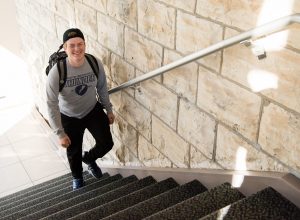 Student walking up steps in Jolliffe Hall